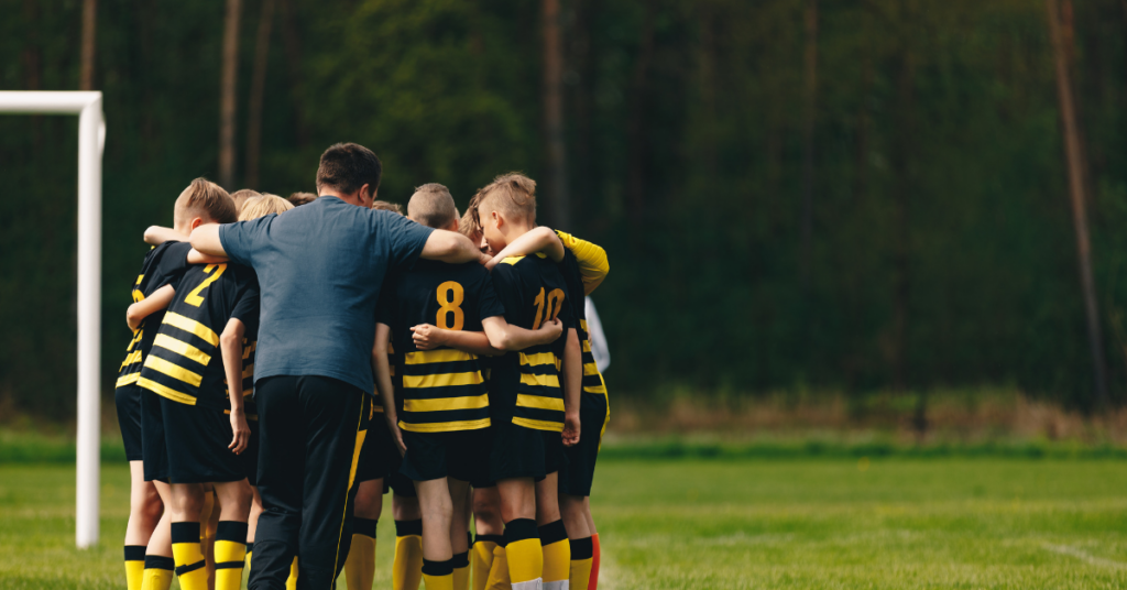 soccer team with their coach positive coaching with Hey Coach