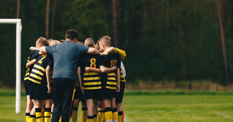 soccer team with their coach positive coaching with Hey Coach