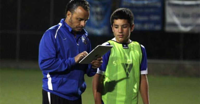 sports coach using an app to track the progress of his athlete using Hey Coach