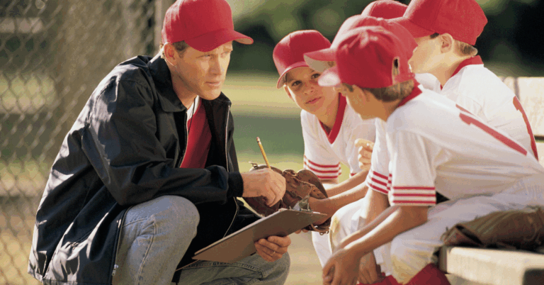 Coach encouraging the team of young players