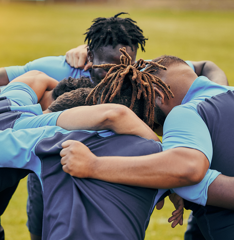 Team huddled together, encouraging each other